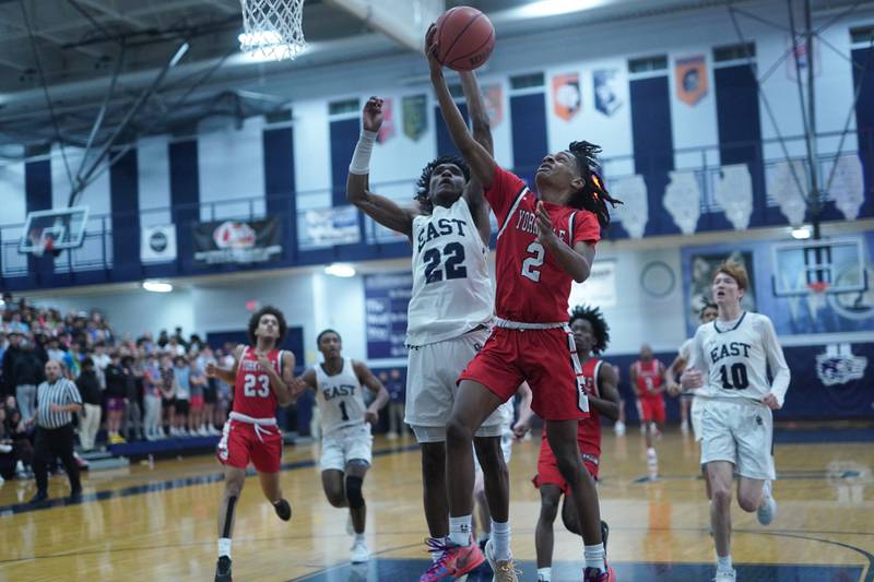 Yorkville's Michael Dunn (2) drives to the hoop against Oswego East's Jehvion Starwood (22) during a basketball game at Oswego East High School on Friday, Dec 8, 2023.