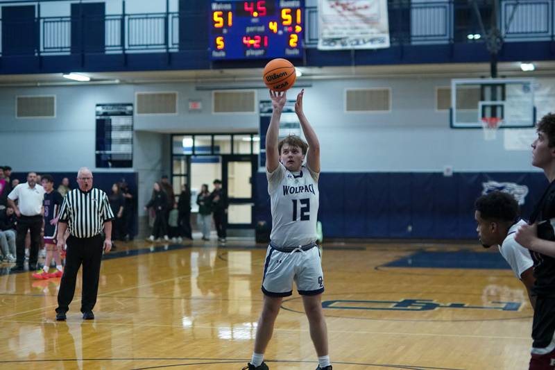 Oswego East's Lukas Adolfs (12) shoots a free throw late in the 4th quarter to give Oswego East the lead over Plainfield North during a basketball game at Oswego East High School on Friday, Dec. 6, 2024.