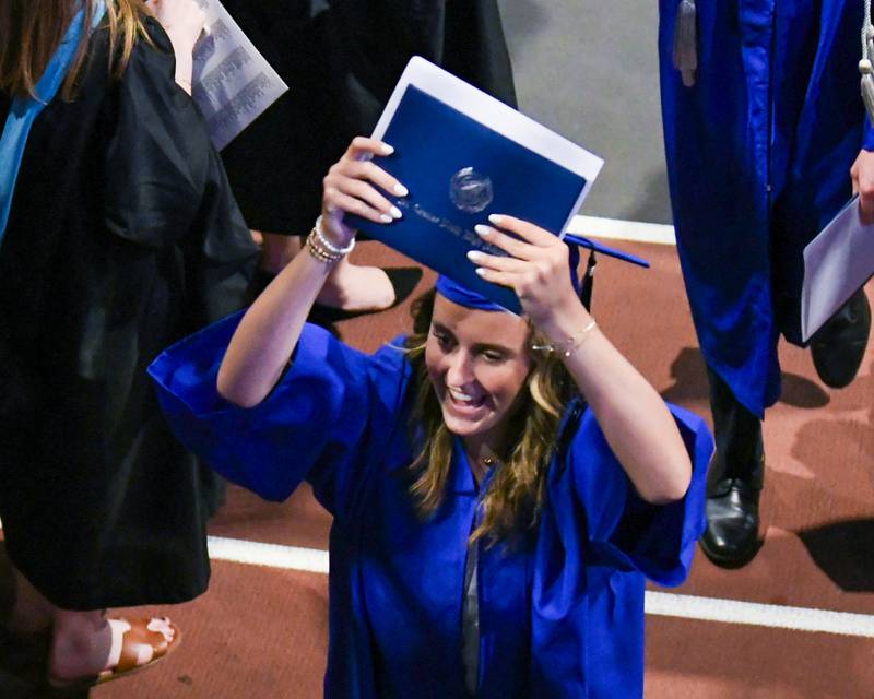 A St. Charles North graduate shows off a diploma during the graduation ceremony on Monday May 18, 2026, held at the NIU Convocation Center in DeKalb.