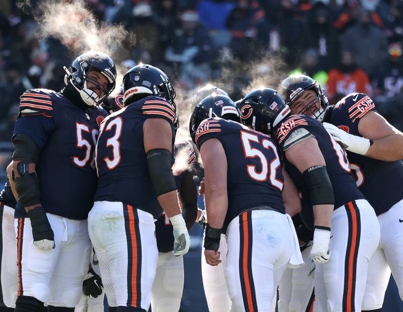 Steam rises from the Chicago Bears huddle in the frigid temperatures during their game Sunday, Dec. 14, 2025, at Soldier Field in Chicago.