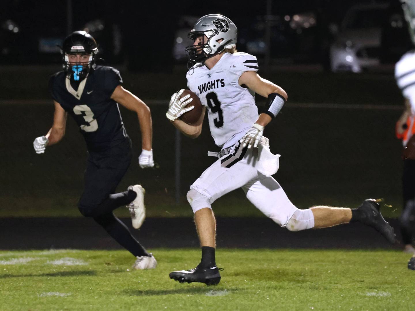 Kaneland's Carter Grabowski outruns Sycamore's Benjamin Anderson for a touchdown during their game Friday, Oct. 3, 2025, at Sycamore High School.