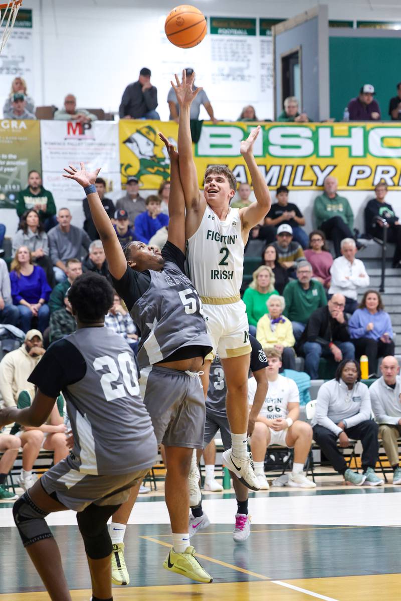 Bishop McNamara's Gavin Antons puts up a shot under pressure during the Fightin' Irish's 70-51 loss to Hope Academy on Tuesday, Dec. 9, 2025