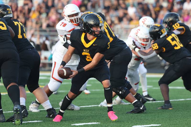 Joliet West’s Juan Rico looks to handoff the ball against Shepard on Friday, Aug. 25, 2023 in Joliet.