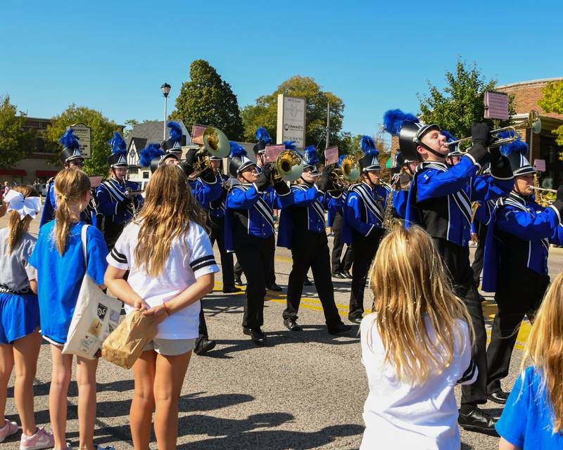 Children watch as the Geneva High School Marching Band performs in the school's homecoming parade on Friday, Sept. 26, 2025, along State Street in downtown Geneva.