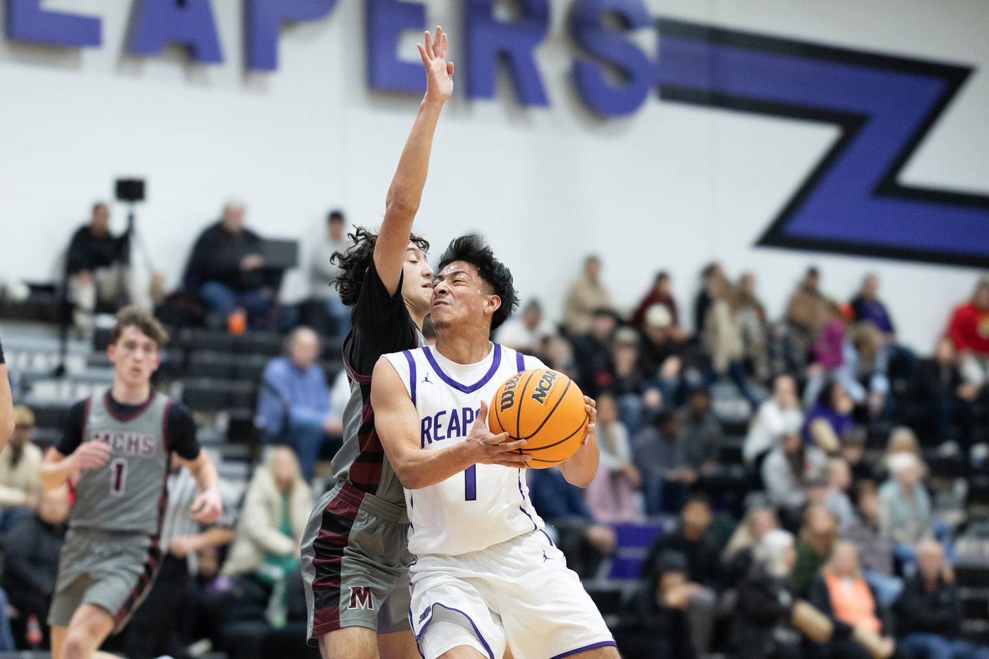 Plano's Alan Contreras (1) hangs in the air on a drive to the basket during Wednesday's game with Marengo in Plano.