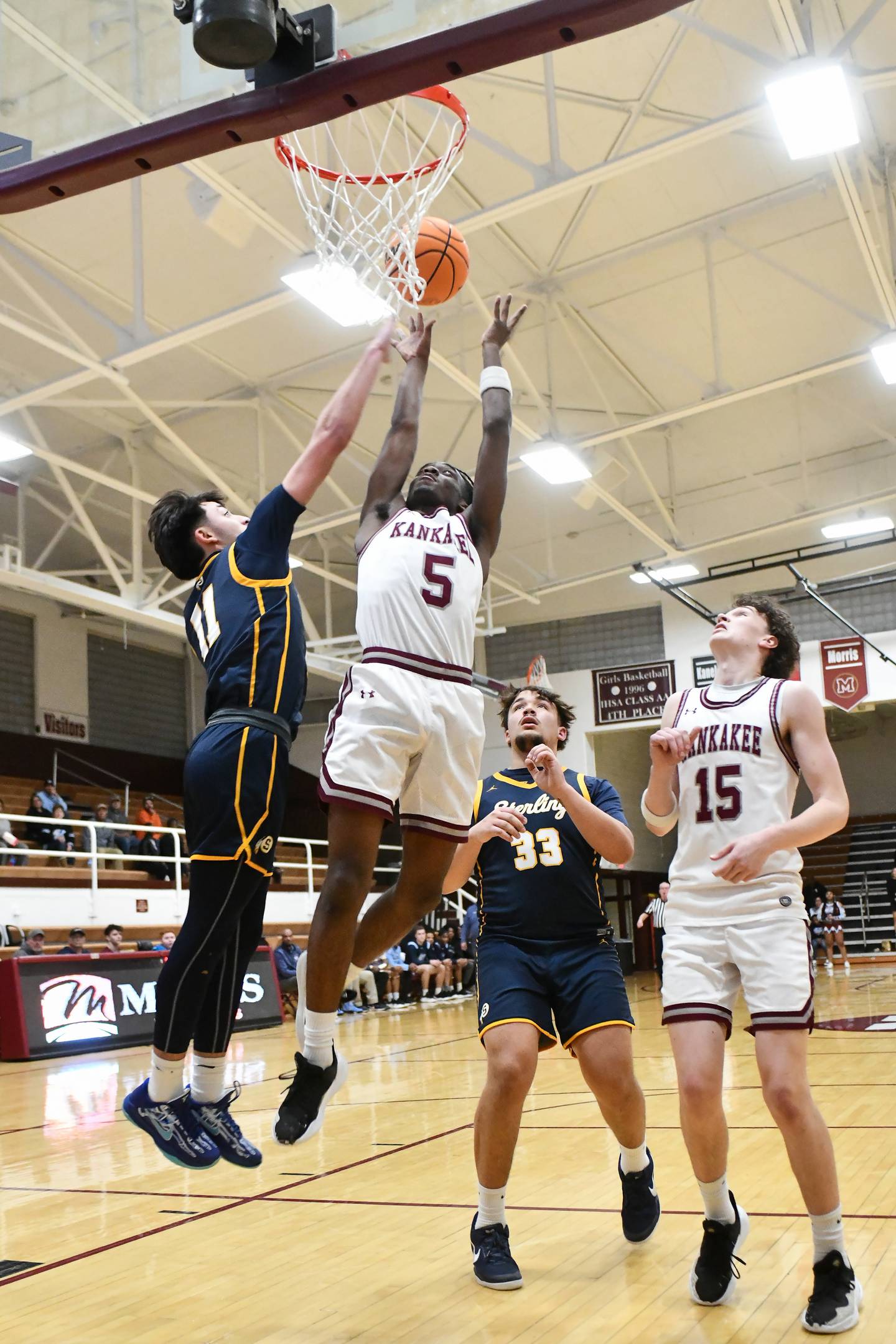 Kankakee's Cedric Terrell III shoots under pressure from Sterling's Nico Battaglia (11) during the Kays' 85-50 victory over Sterling in the IHSA Class 3A Morris Regional championship on Friday, Feb. 28.