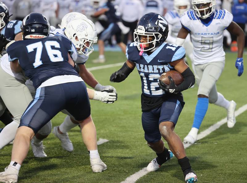 Nazareth's Edward Mcclain Jr. (12) runs against St. Francis during the boys varsity IHSA 5A semifinal between Nazareth Academy and St. Francis high school in La Grange Park, IL on Saturday, Nov. 18, 2023.