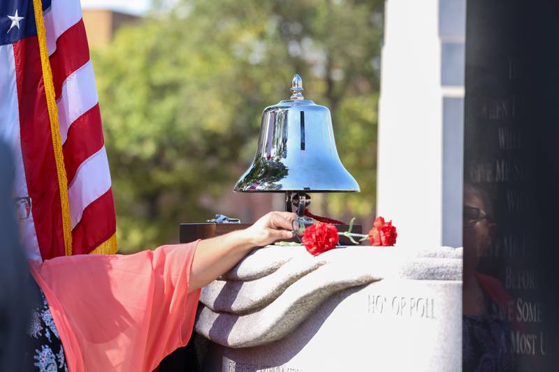 Flowers are placed upon the memorial wall as each of Kankakee County's eight fallen firefighter's names are read aloud during the 44th Kankakee County Fallen Firefighter Memorial Service on Friday, Oct. 3, 2025.