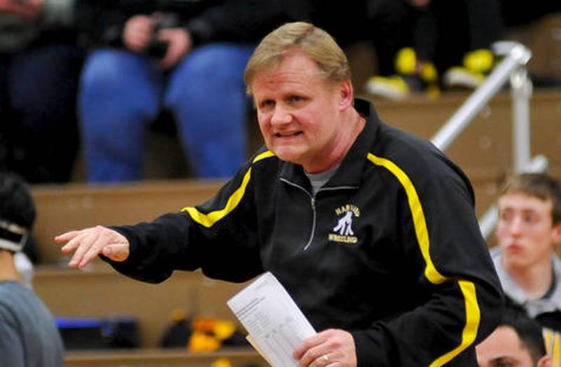 Harvard wrestling coach Tim Haak gives advice to a wrestler during the Class 1A Wrestling Dual Team Sectional in February. Haak, who also coaches Harvard's football team, will retire after this school year.