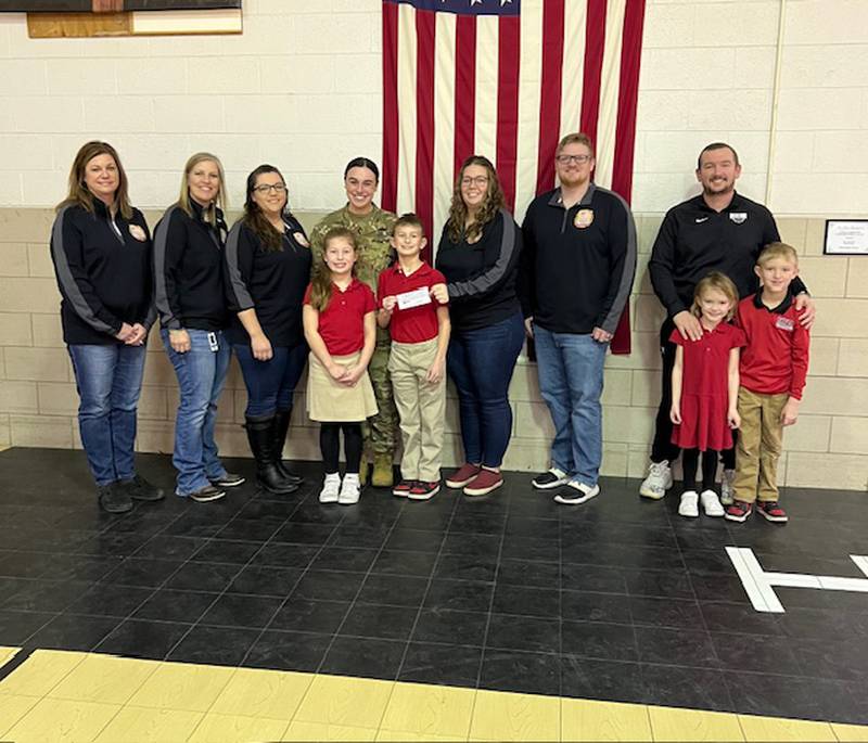 Oglesby Holy Family School students donated to the La Salle County Veterans Assistance Commission. Pictured are representatives from the VAC, along with Lt. Maddie Keegan with Jase and Berkley Keegan and Marine Corps veteran Justin Rubley with River and Raven Rubley.