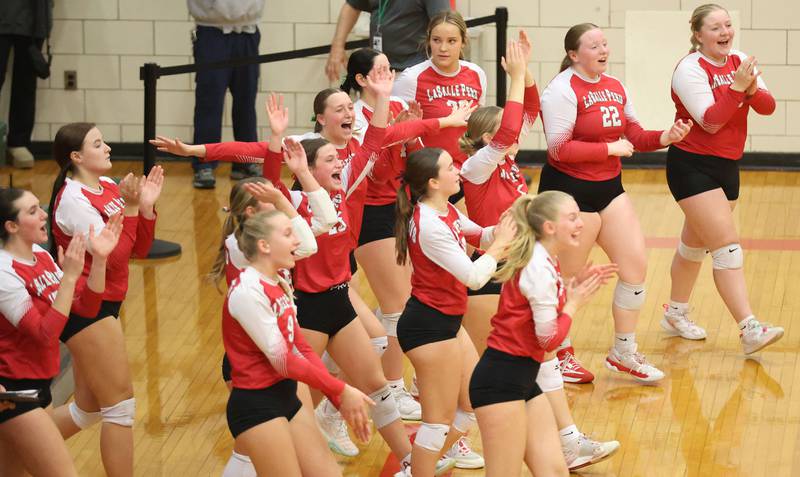 Members of the L-P volleyball team react after scoring a point during the Class 3A Sectional final game on Thursday, Nov. 6, 2025 in Sellett Gymnasium at L-P High School.
