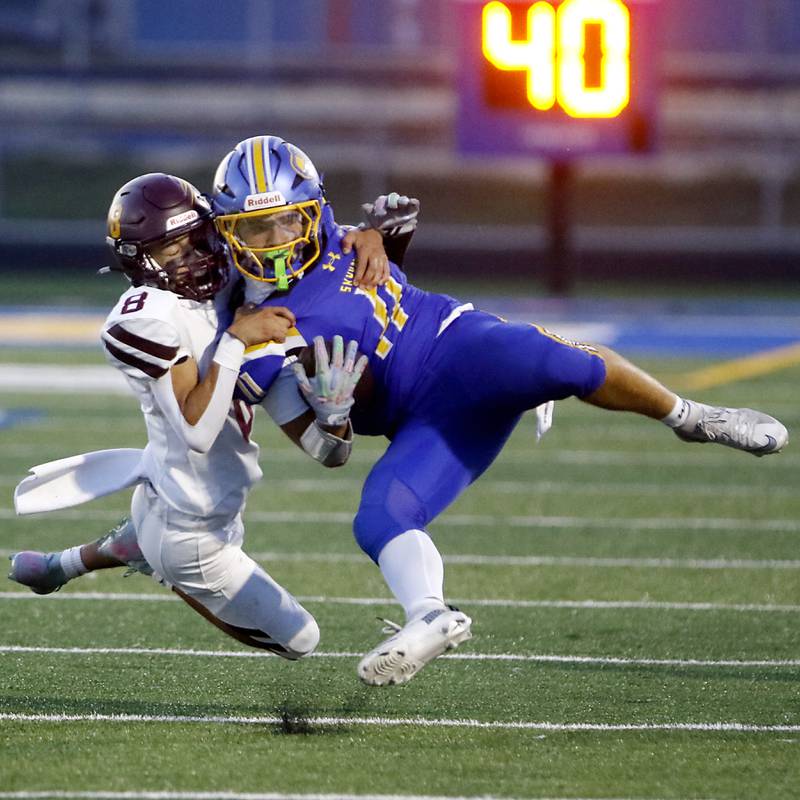 Richmond-Burton's Joseph Larsen tackles Johnsburg's Ryan Franze after Franze  caught a pass during a Kishwaukee River Conference football game on Friday, Sept. 12, 2025, at Johnsburg High School.