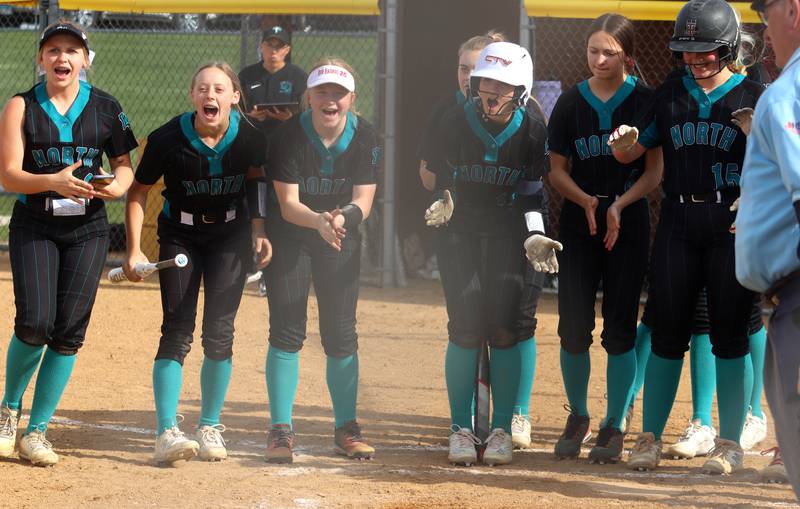 Woodstock North’s Thunder prepare to greet Casey Vermett on her first of two home runs against Jacobs in varsity softball at Algonquin Friday night.