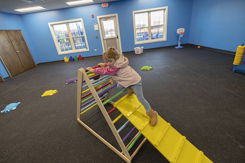 Madalynn Parola, 3, of La Moille explores a toy in one of two gross motor skills rooms Thursday, Jan. 9, 2025, at the new YMCA Child Care Center. The daycare held an open house for families enrolled in the program.