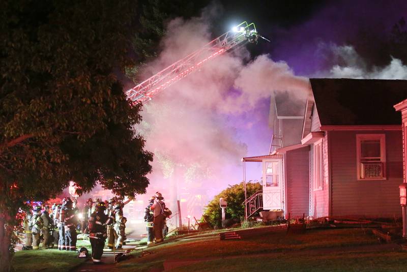Firefighters work the scene of a structure fire in the 100 block of West Cleveland Street on Thursday, May 15, 2025 in Spring Valley. The fire broke out shortly before 8:30p.m. Fire departments from La Salle Bureau and Putnam Counties responded to the scene. A mutual aid box alarm system (MABAS) call was issued prompting the response.