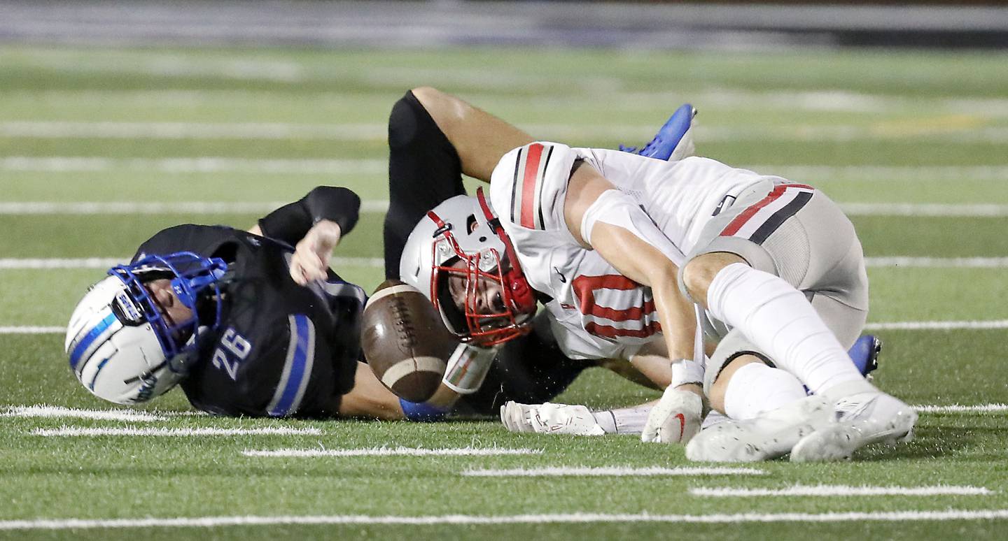 Palatine's Connor May (10) and St. Charles North's Aidan McClure (26) collide after a dropped pass Friday August 25, 2023 in St. Charles.