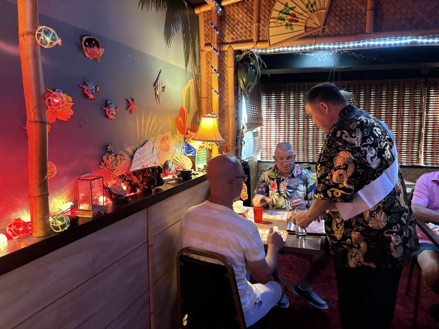 Danny Kakazu, right, talks with Ryan Healy and Lance Schulte during his retirement party at the Breakers in Crystal Lake June 29, 2025.