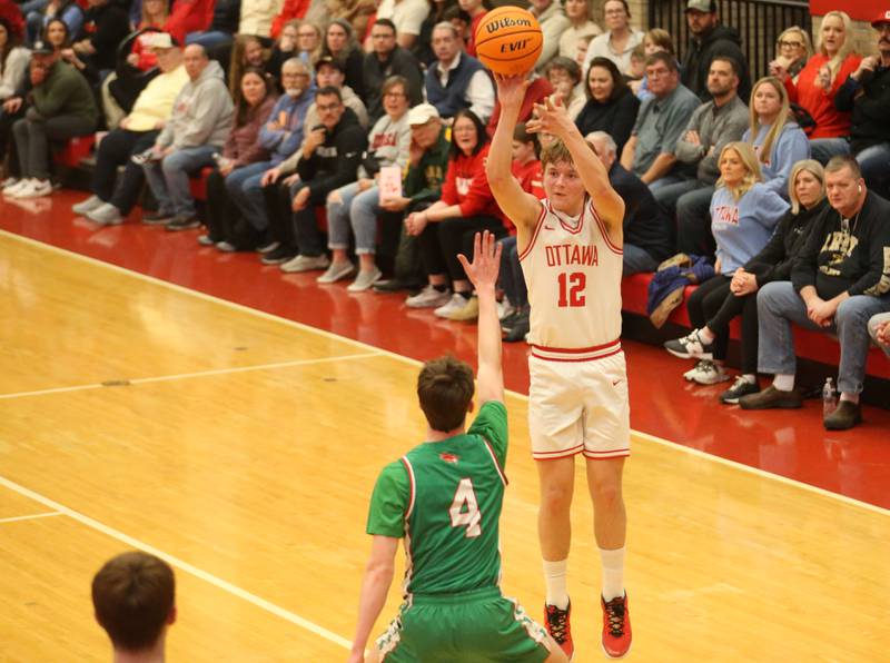 Ottawa's Jack Carroll lets go of a jump shot over L-P's John Sowers on Friday, Feb. 6, 2026 in Kingman Gymnasium at Ottawa High School.