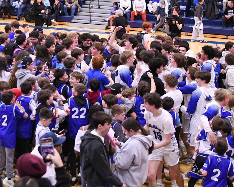 Riverside-Brookfield students storm the court after taking the win over Glenbard East on Tuesday Feb. 3, 2026, held at Riverside-Brookfield High School.