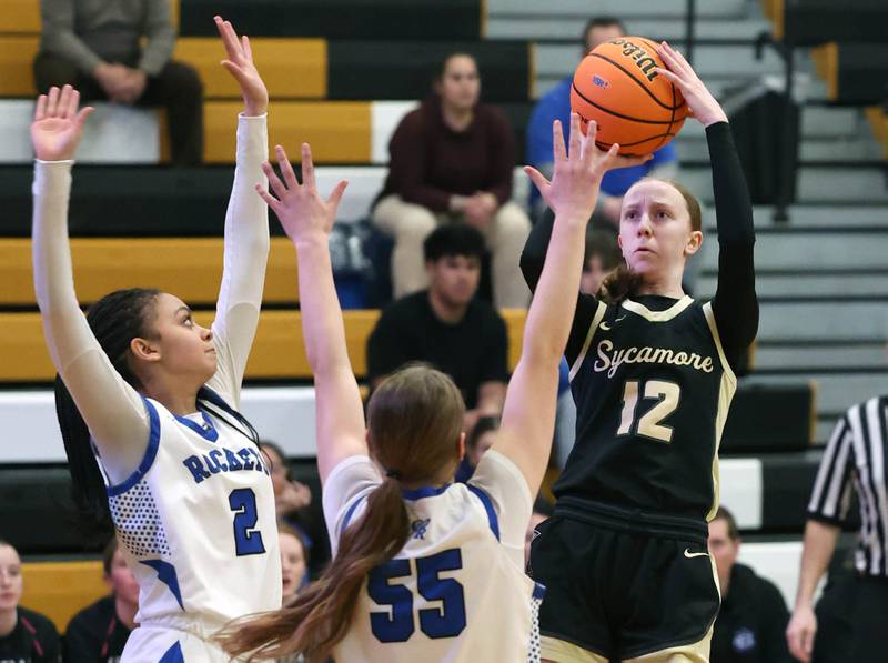 Sycamore's Sadie Lang shoots the ball over a pair of Burlington Central defenders Thursday, Feb. 19, 2026, during their Class 3A regional championship game at Sycamore High School.