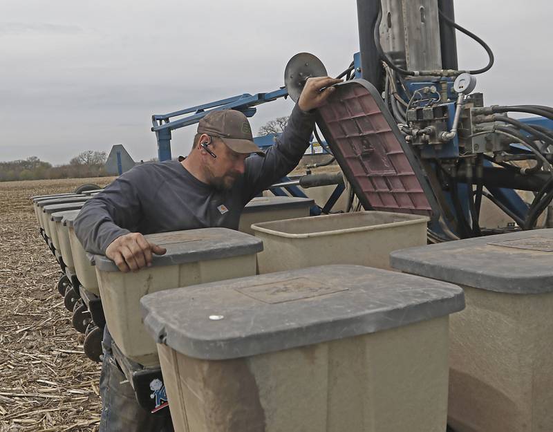 Chris McKee checks his planting set up Friday, April 28, 2023, as he prepares to plant soybeans near Woodstock.