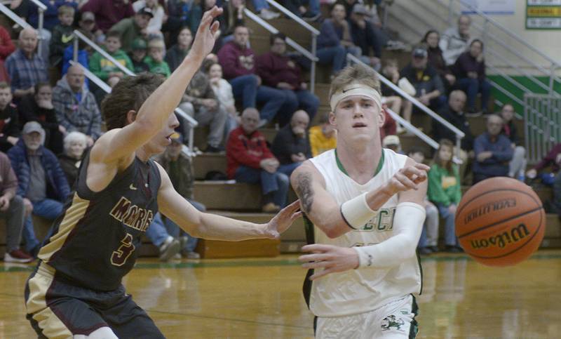 Seneca’s Paxton Giertz (at right) fires a no-look pass while being defended by Morris' Caston Norris (3) Tuesday, Nov. 28, 2023, in Seneca.