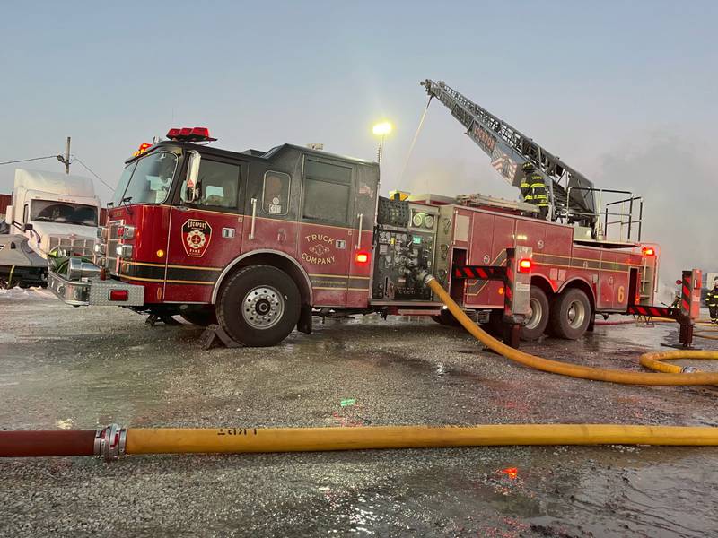 Firefighters battle a blaze on Dec. 24, 2022, at Gasnas Trucking in Lockport Township.