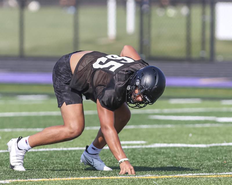 Aiden Solecki gets in his stance at Downers Grove North High School football practice, Thursday, Aug 14, 2025  in Downers Grove.