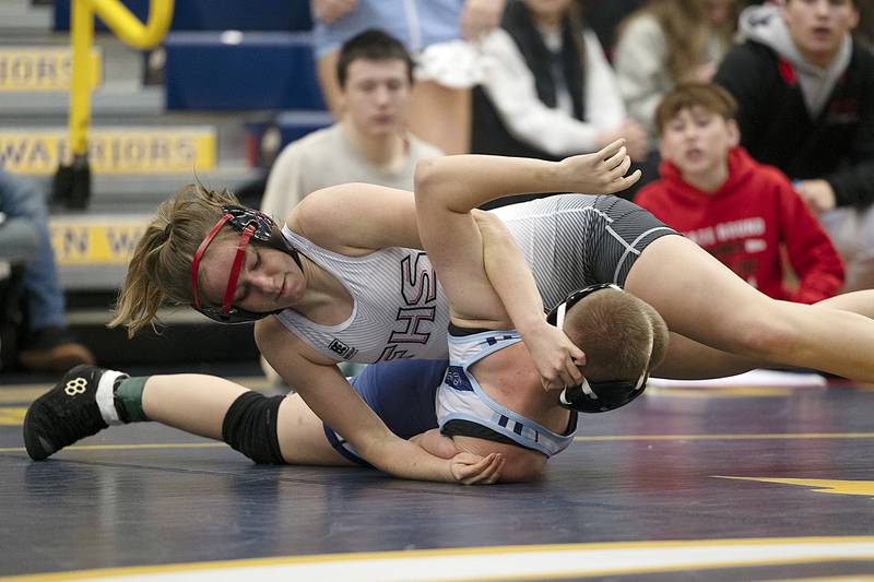 Fulton’s Grace Bray goes for the pin against Plainfield South’s Gabi Mardual in the 125 pound finals Saturday, Dec. 7, 2024, at the Carson DeJarnatt Invitational. Bray took the win.
