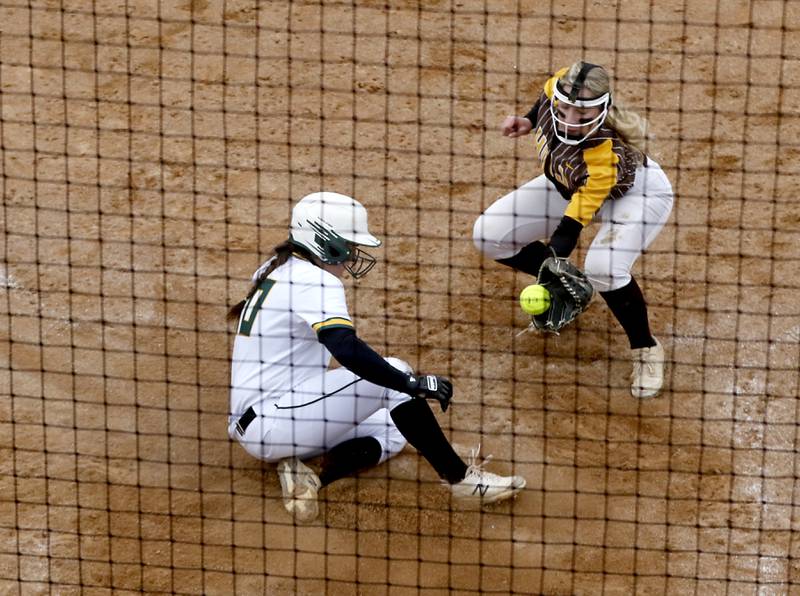 Crystal Lake South's Alexis Pupillo slides into home as Jacobs’s Caitlin Cook fields the throw during a Fox Valley Conference softball game Monday, April 25, 2022, between Crystal Lake South  and Jacobs at Crystal Lake South High School.