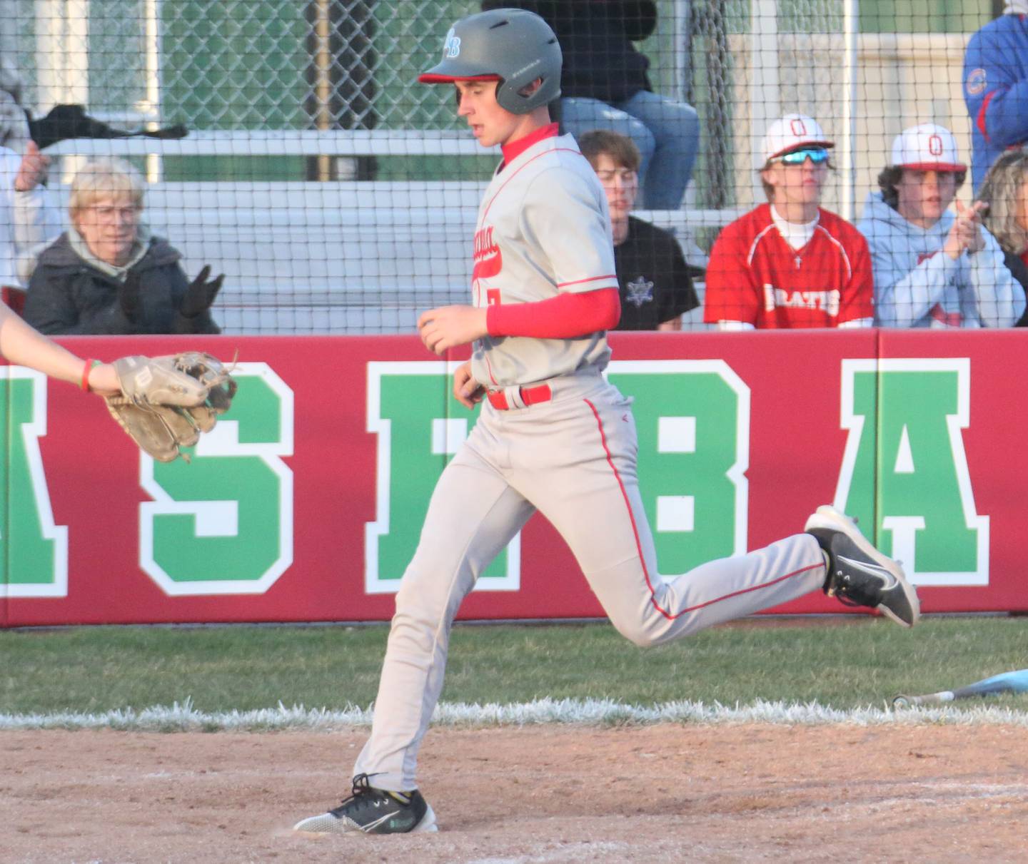 Ottawa's Lucas Farabauch steps on home plate to score a run against L-P at Huby Sarver Field inside the L-P Athletic Complex on Tuesday, April 23, 2024 in La Salle.