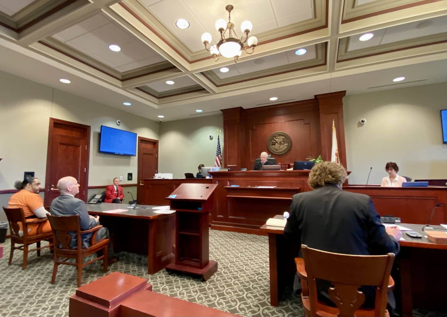 (Left) Jimmy Edwards, 36, of DeKalb, pleads guilty Monday, April 15, 2024, to one count of armed violence, a Class X felony. Part of a plea deal agreed upon by prosecutors and accepted by Circuit Court Judge Philip Montgomery, (middle) he will be sentenced to 18 years in prison if he testifies truthfully in an upcoming trial expected for two of his co-defendants, including his brother, in the July 4, 2020 fatal shooting of Chrishun Keeler-Tyus. Jimmy pleaded in front of Montgomery with his defense lawyer Andrew Nickel (second from left) at the DeKalb County Courthouse, 133 W. State St. in Sycamore. He was originally charged with first-degree murder.