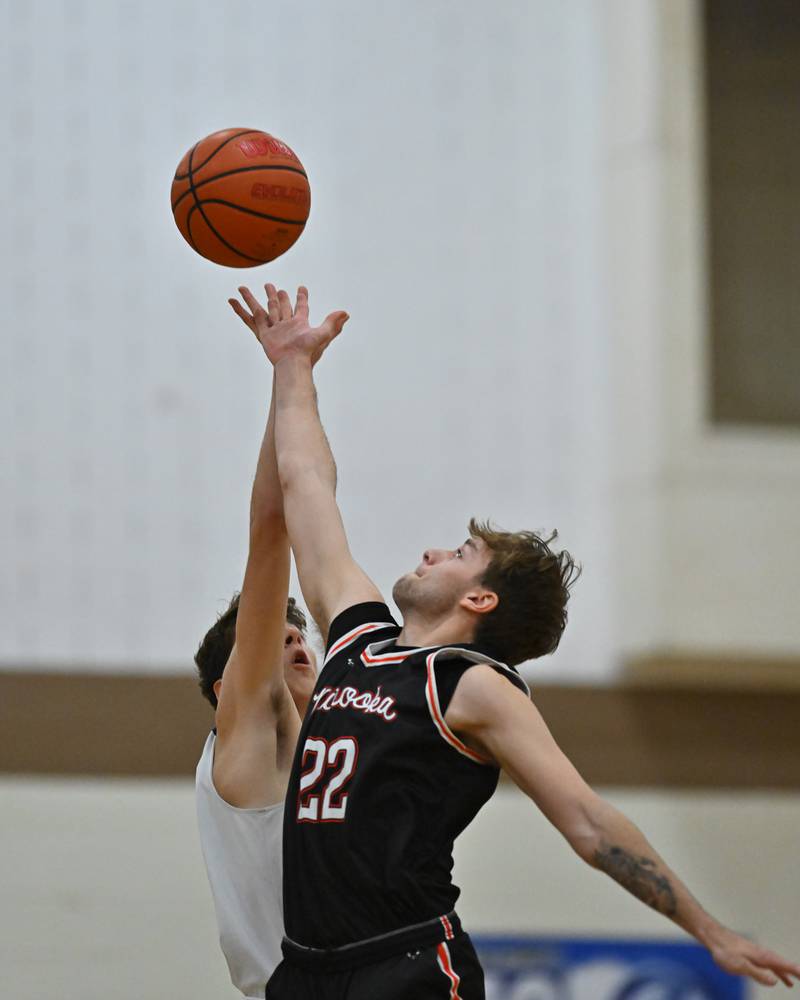 Minooka's Nick Andreano (22) goes up for the opening tip-off in the WJOL Basketball Tournament on Monday, November 21, 2022, at Joliet.