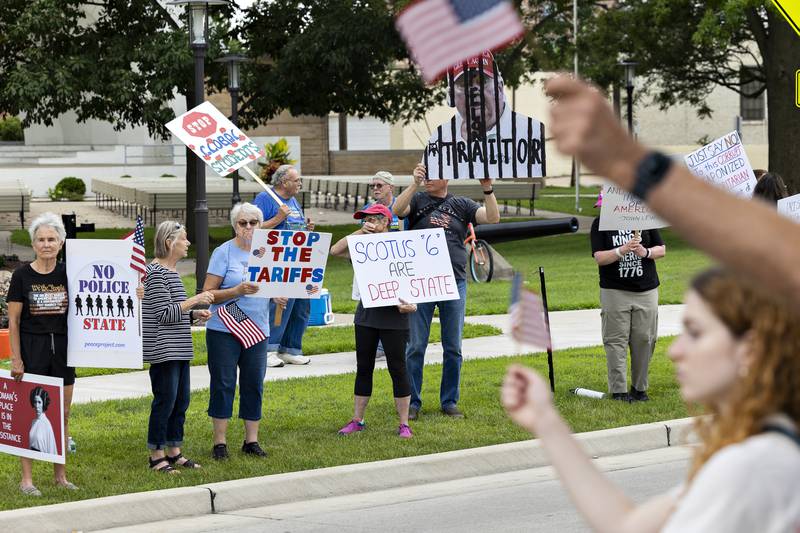 Protesters line East Fourth Street in Sterling on Thursday, July 17, 2025.