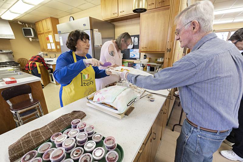 Loaves and Fishes volunteers Jackie Warkins dishes up a breakfast to Fred Hand Wednesday, March 29, 2023 at First United Methodist Church. The Sterling church offers a free to go breakfast Monday, Wednesday, Thursday and Friday from 9am to 11am.
