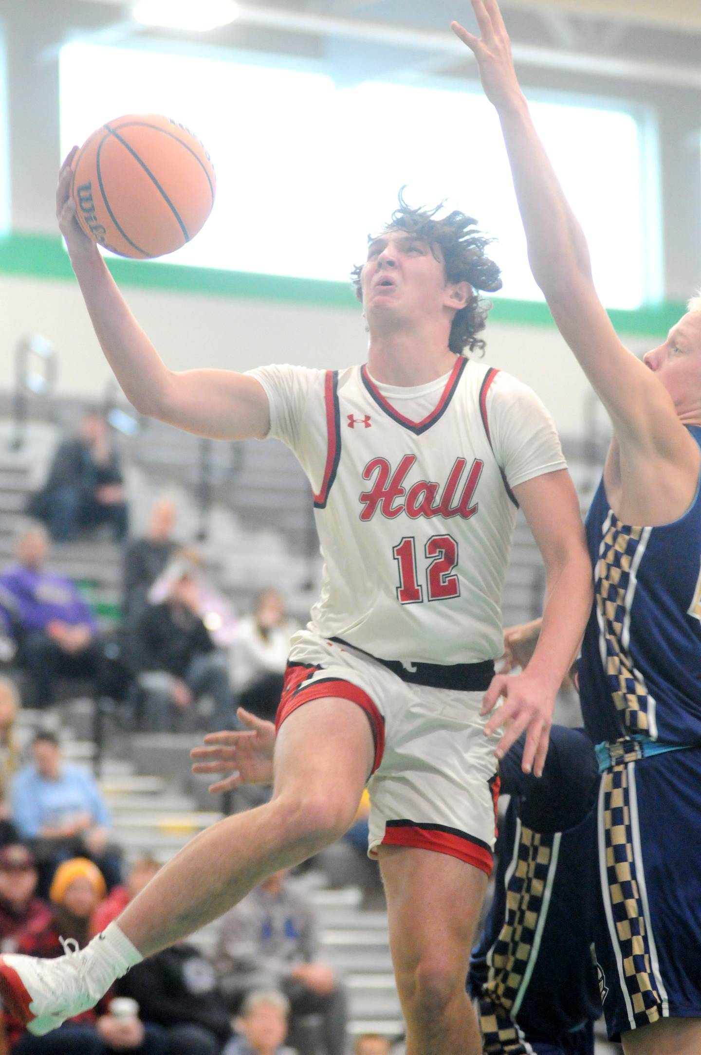 Hall's Jack Jablonski shoots past Marquette's Luke McCullough on Thursday, Dec. 26, 2024, at Seneca High School.