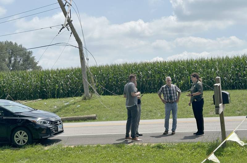 Ogle County Sheriff Chief Deputy Danielle Hardesty (right) talks with FAA officials as they arrive in response to a fatal plane crash along Illinois Route 64 near the Ogle County Airport between Oregon and Mt. Morris on Tuesday, July 22, 2025. The pilot of the plane was killed after hitting power lines near the airport and crashing.