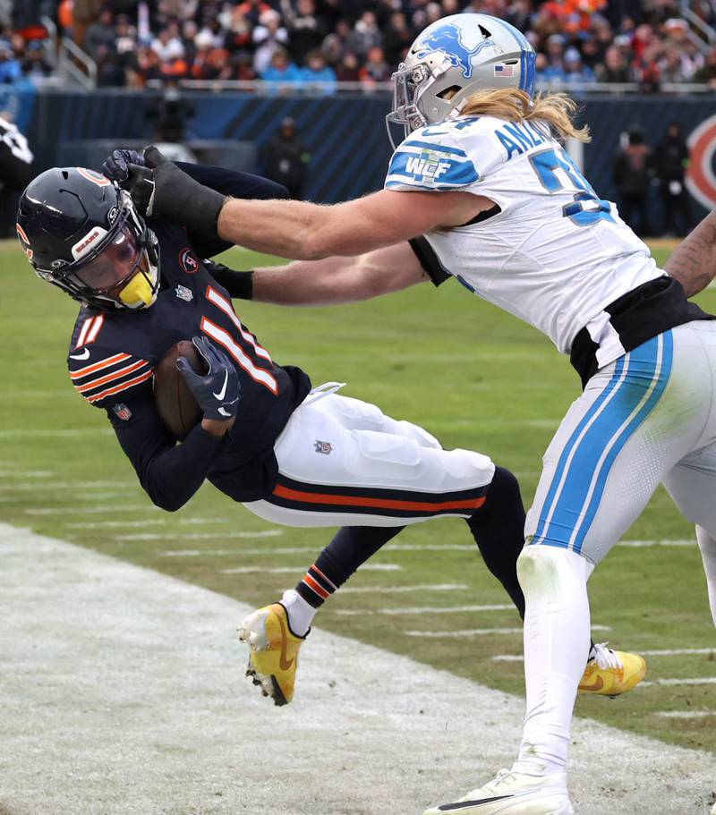 Chicago Bears wide receiver Darnell Mooney is hit late out-of-bounds by Detroit Lions linebacker Alex Anzalone during their game Sunday, Dec. 10, 2023 at Soldier Field in Chicago. Anzalone was penalized for unnecessary roughness on the play.