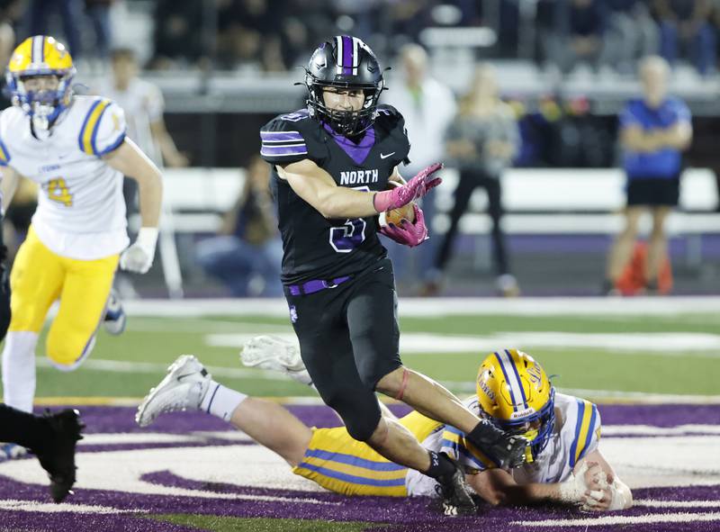 Downers Grove North's Ethan Kist  (3) runs back an interception during the varsity football game between Downers Grove North and Lyons Township on Friday, Oct. 11, 2024 in Downers Grove.
