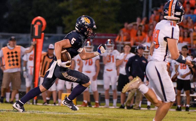 Neuqua Valley's Grant Larkin (5) runs the ball against the Oswego during the first half of varsity football in Naperville on Friday, August 27, 2021.