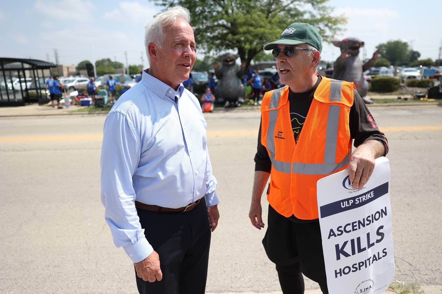 Joliet Mayor Terry D’Arcy speaks with retired union worker Charley Lane, who is supporting the striking nurses, on the first day of a two day strike, followed by a two day lockout outside Ascension Saint Joseph-Joliet hospital on Tuesday, Aug. 22, 2023.