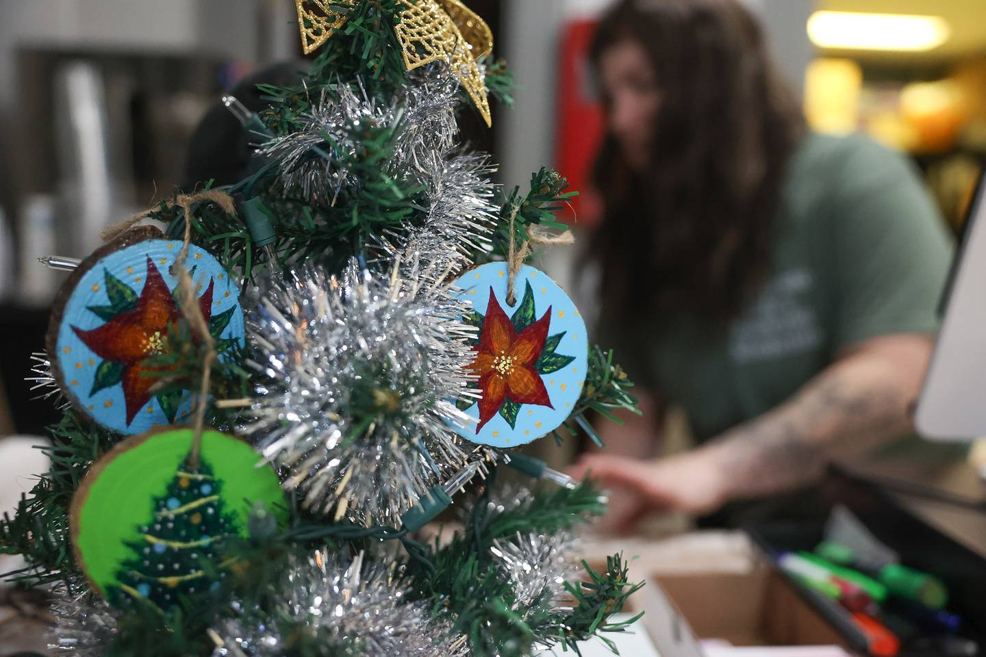 Hand-painted ornaments by Gregg Obodvinski hang on a tree at Springview Sweets Bakery located at the Lockport Metra train station in downtown Lockport on Friday, Dec.15th. Owner Megan DiCaro plans to feature and sell art work by locate artist at her bakery.