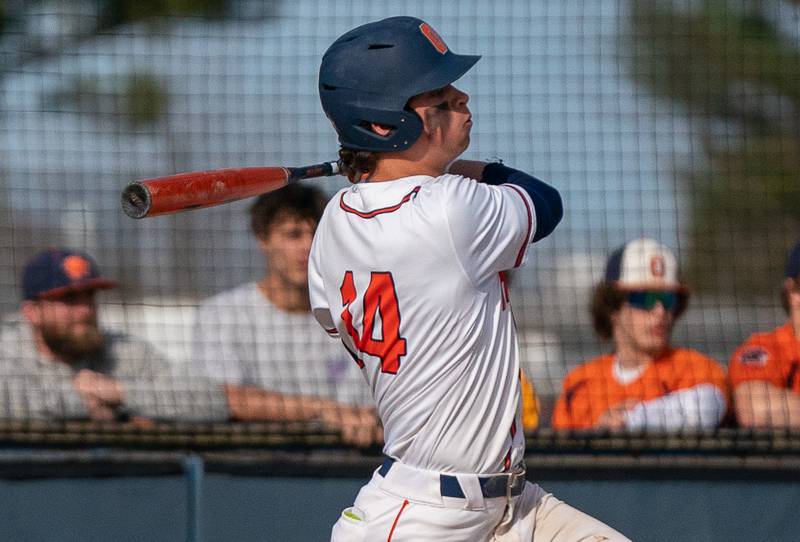 Oswego’s Trey Hernandez (14) singles against Plainfield South during a baseball game at Oswego High School on Monday, April 11, 2022.