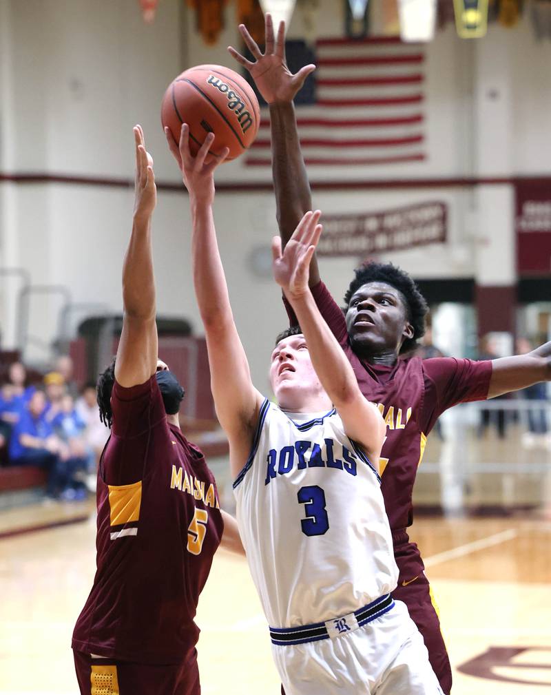 Hinckley-Big Rock's Ben Hintzsche gets a layup in front of two Chicago Marshall defenders Wednesday, March 1, 2023, during their Class 1A sectional semifinal matchup at Elgin High School.