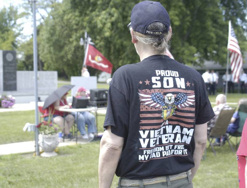 Russ Martin of Rock Falls stands as flags are presented during the ceremony at Coloma Township Cemetery. Twin City American Legions marked Memorial Day with various events on Monday, May 25th, 2026. Events included a Rifle Volley, playing of Taps, a Memorial Day Service and an American Flag mural dedication.