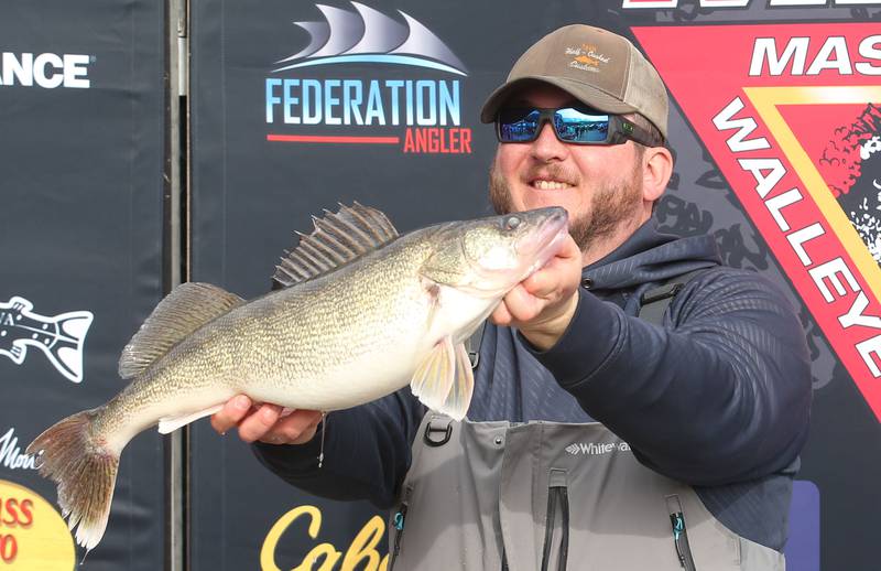 Ryan Feldott of Spring Valley holds his monster walleye fish that he caught during the annual Masters Walleye Circuit tournament on Friday, March 21, 2025 at the Spring Valley Boat Club.