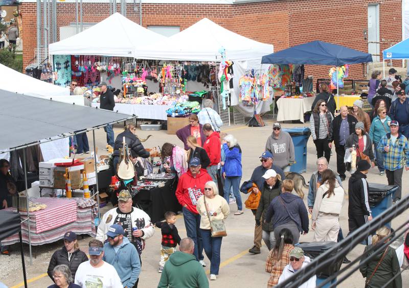 People walk behind Mill Street during the 53rd annual Burgoo on Sunday, Oct. 8, 2023 downtown Utica.