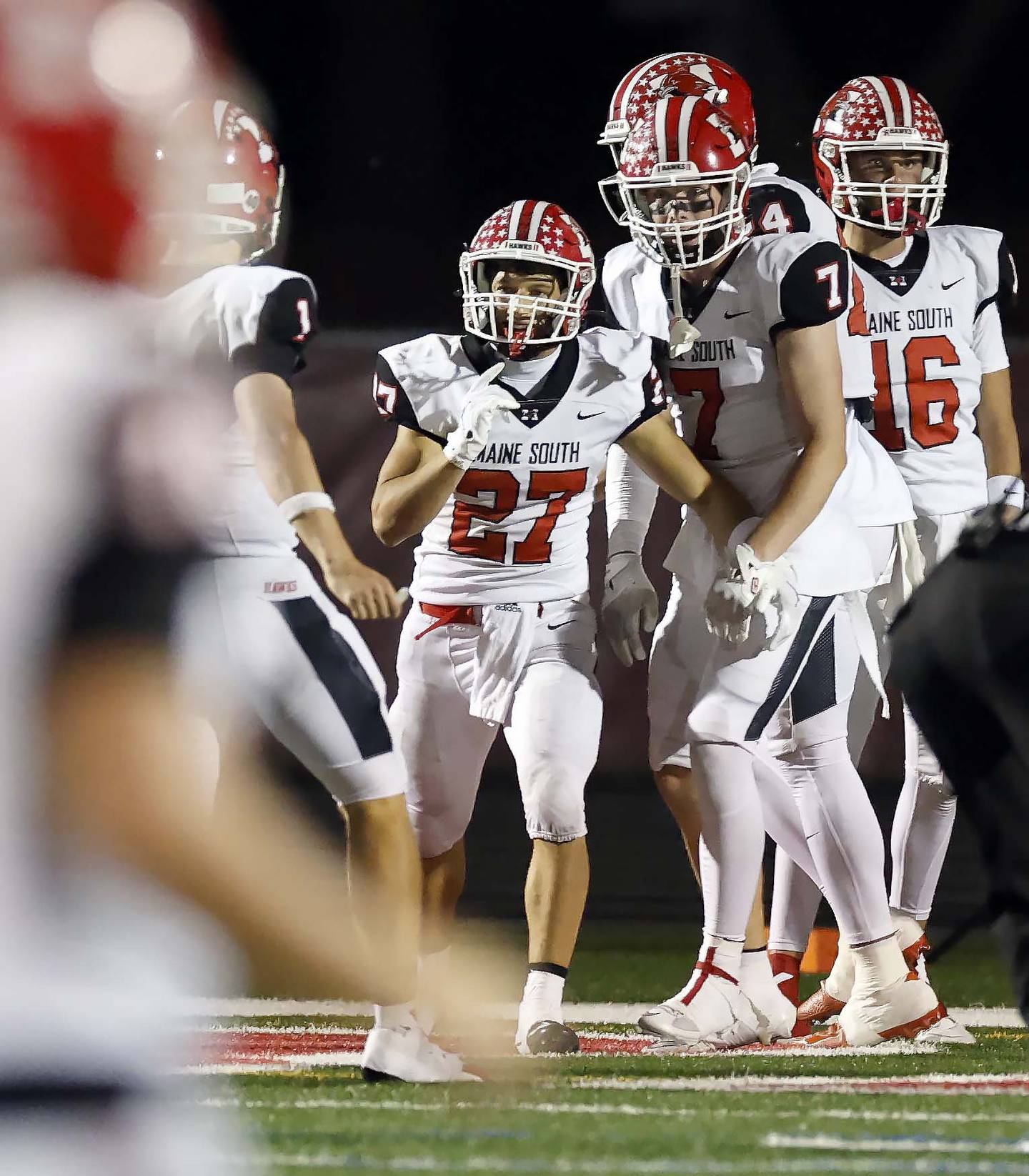 Maine South's Niko Kokosioulis (27) celebrates a touchdown with his teammates Friday, Sept. 19, 2025 in Barrington.