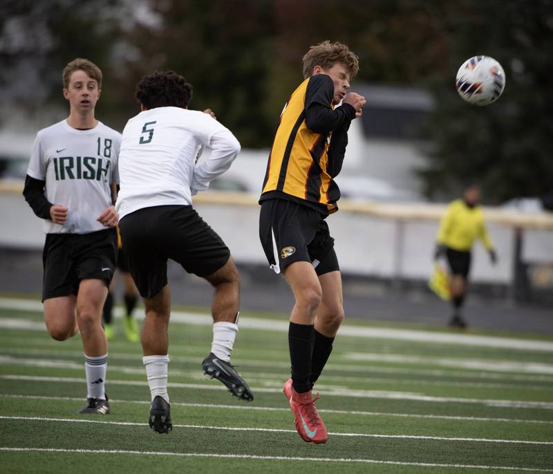 Herscher's Drake Bushey, right, and Bishop McNamara's Diego Perez, left, play the ball in a regional match-up on Tuesday, October 21, 2025.