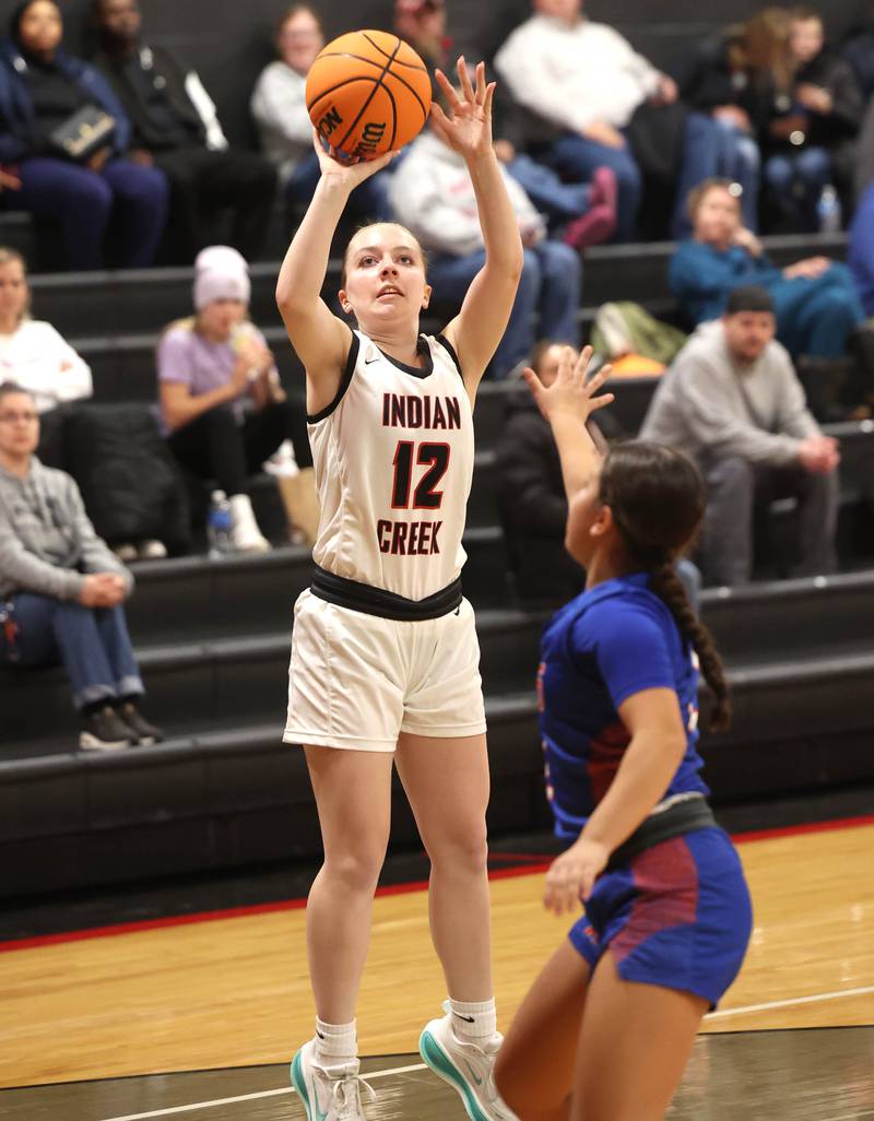Indian Creek's Bethany Odle shoots over Genoa-Kingston's Ayva Hernandez Monday, Dec. 8, 2025, during their game at Indian Creek High School in Shabbona.